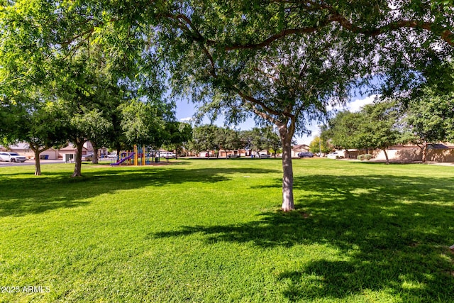 view of home's community with a yard and playground community