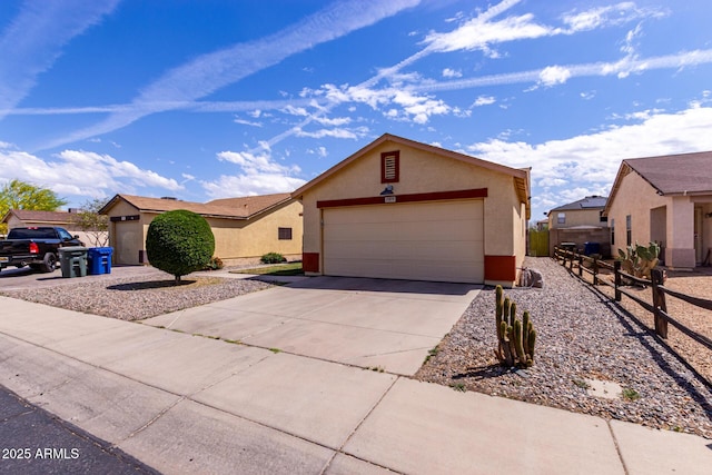 ranch-style house with stucco siding, fence, concrete driveway, and a garage
