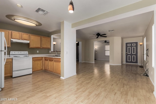 kitchen featuring open floor plan, visible vents, white appliances, ceiling fan, and light countertops