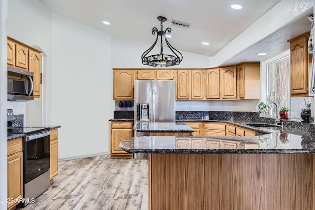 20006 W Highland Ave, Litchfield Park, AZ 85340 - kitchen featuring dark stone countertops, a sink, visible vents, appliances with stainless steel finishes, and vaulted ceiling