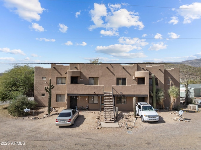 view of front of home featuring cooling unit and stucco siding