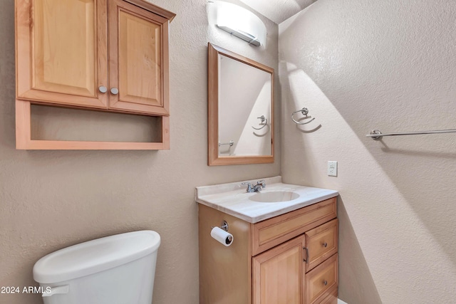 half bath with vanity and toilet