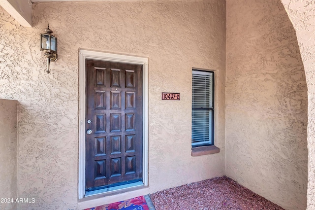 property entrance featuring stucco siding