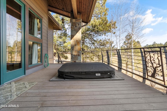 deck with a covered hot tub