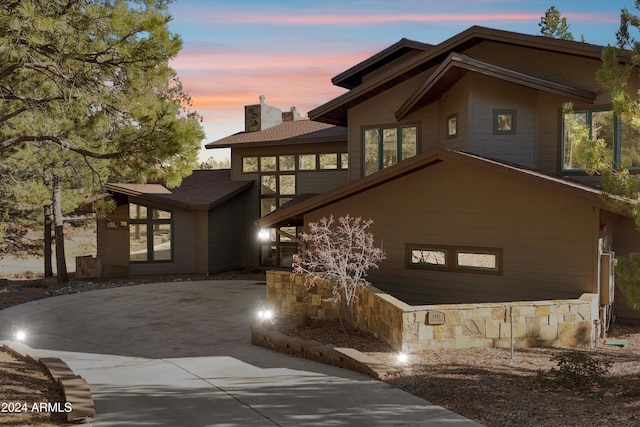 property exterior at dusk with a patio area