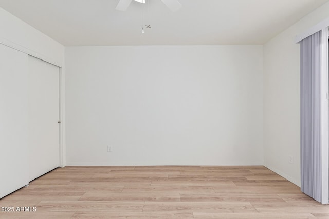 empty room featuring ceiling fan and light wood-type flooring