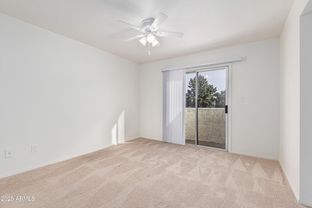 unfurnished room featuring ceiling fan and light colored carpet