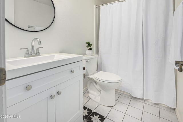 bathroom featuring vanity, toilet, and tile patterned floors