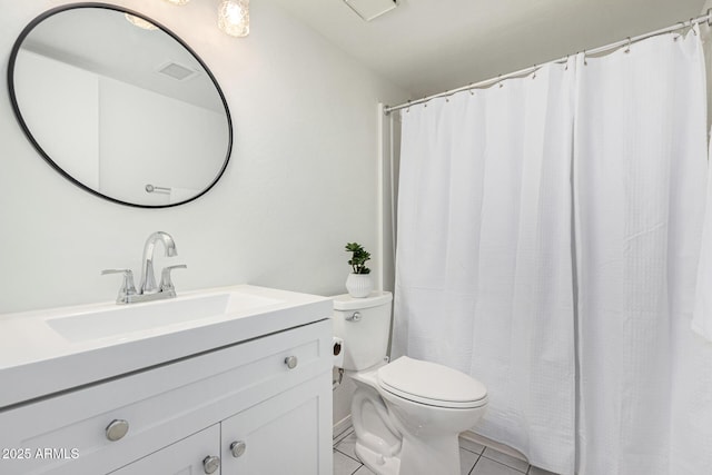 bathroom featuring vanity, toilet, and tile patterned floors