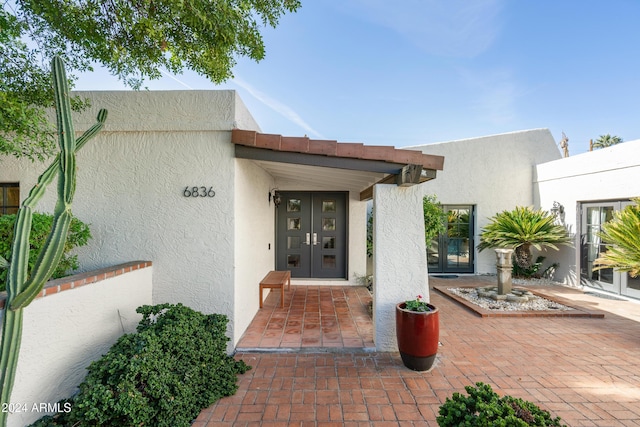 view of exterior entry featuring french doors