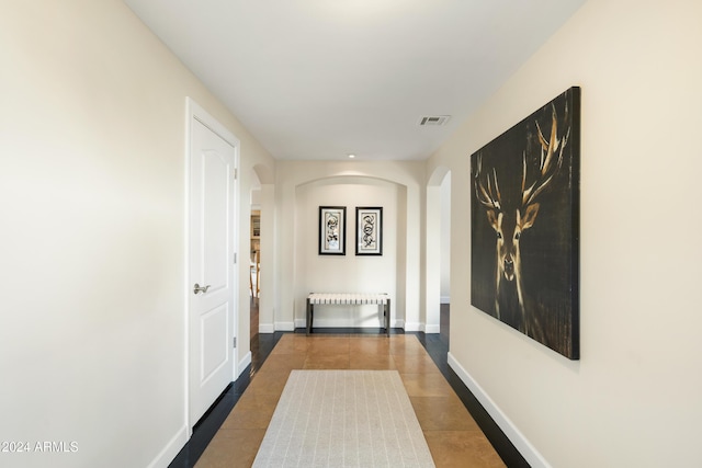 hall with tile patterned flooring