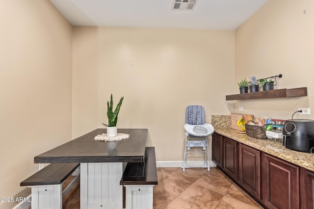 dining space featuring baseboards and visible vents