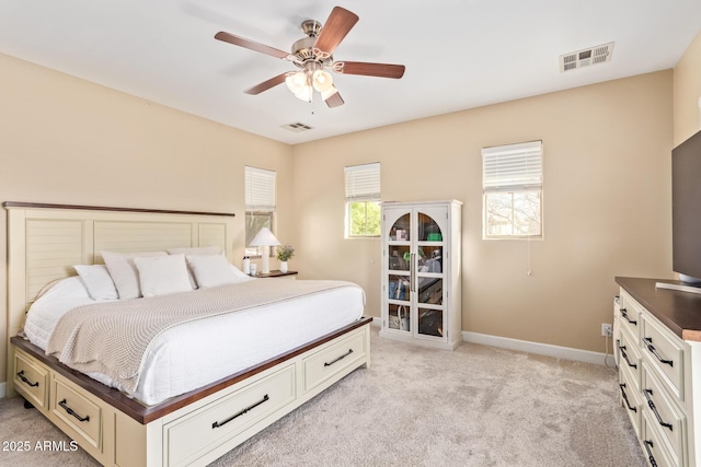 bedroom with visible vents, light carpet, baseboards, and a ceiling fan