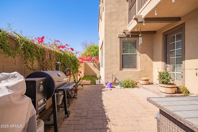 view of patio featuring fence