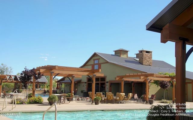 community pool with a patio area and a pergola