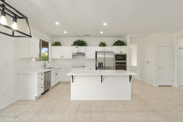 kitchen with sink, light tile patterned floors, stainless steel appliances, a center island, and white cabinets