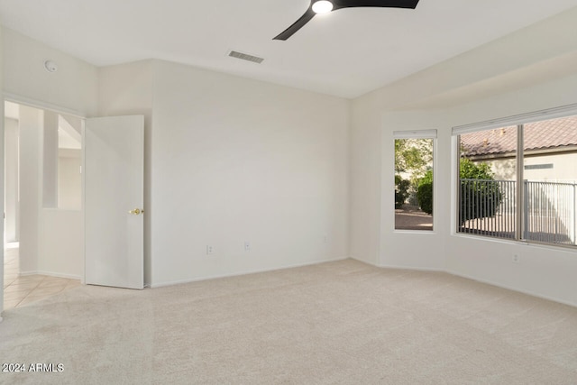 carpeted empty room featuring ceiling fan