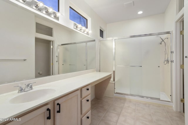 bathroom with vanity, tile patterned floors, and walk in shower