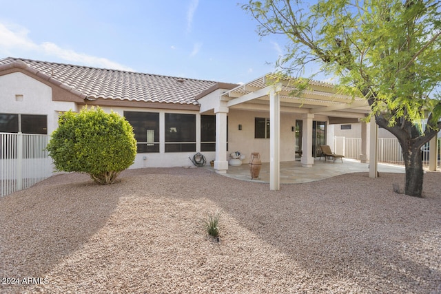 back of house featuring a pergola, a sunroom, and a patio