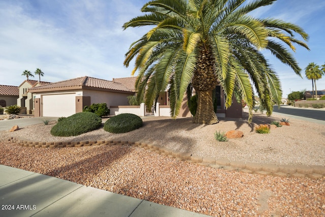 mediterranean / spanish house with a garage