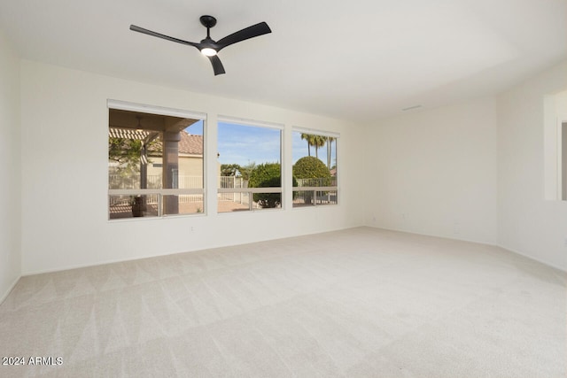 spare room with light carpet and ceiling fan