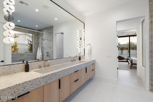 bathroom with dual sinks, an enclosed shower, oversized vanity, and tile flooring