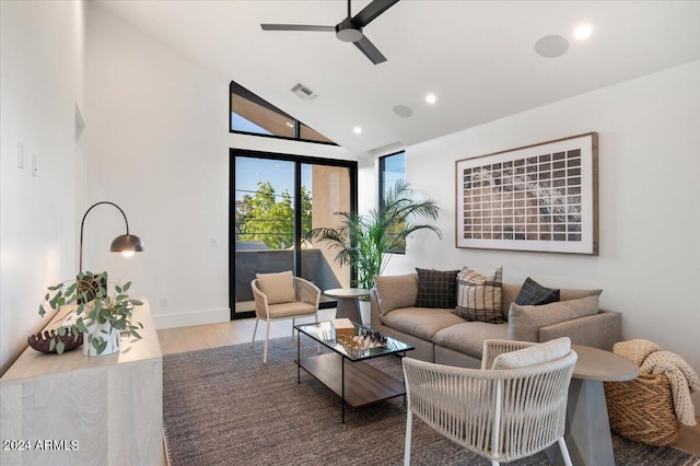 living room with wood-type flooring, ceiling fan, and high vaulted ceiling