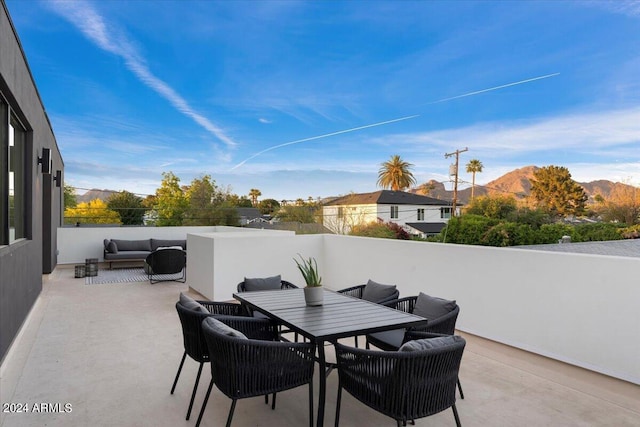 view of patio featuring an outdoor living space and a mountain view