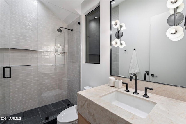 bathroom featuring lofted ceiling, vanity, toilet, and tiled shower