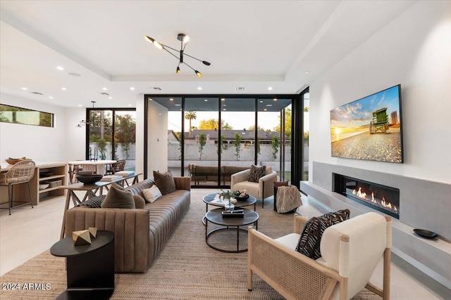 living room featuring expansive windows and a tray ceiling