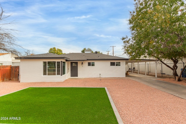 exterior space featuring a front yard and a carport