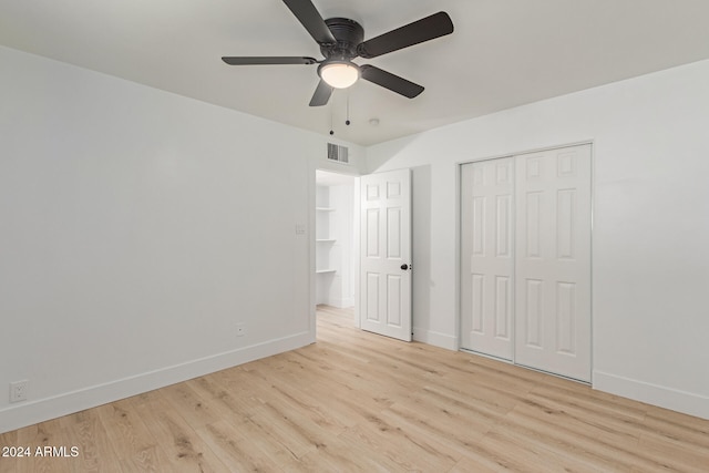 unfurnished bedroom with ceiling fan, a closet, and light hardwood / wood-style flooring