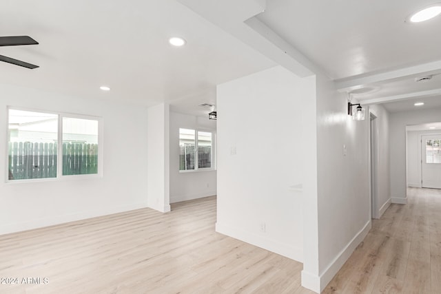 hallway with plenty of natural light and light wood-type flooring