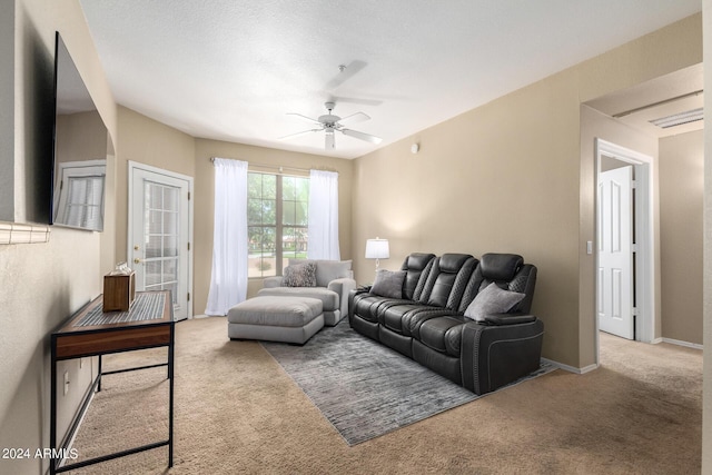 carpeted living room with a ceiling fan and baseboards