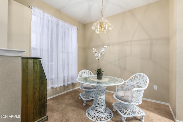 dining space with a chandelier, plenty of natural light, carpet flooring, and baseboards