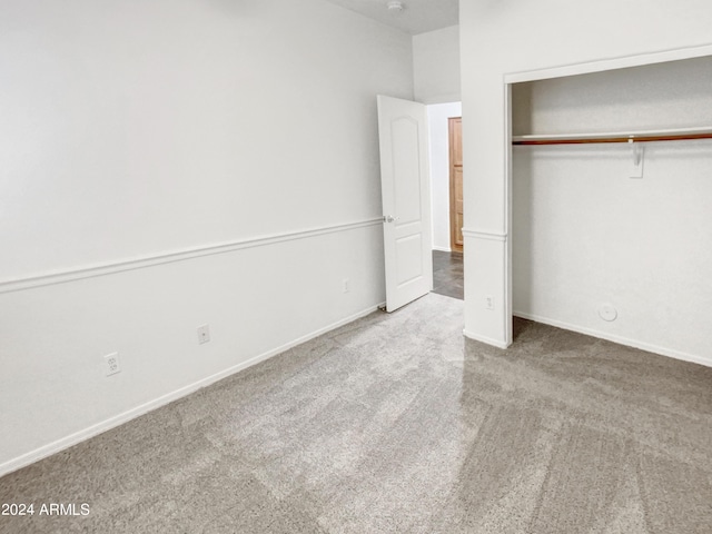 unfurnished bedroom with a closet, baseboards, and carpet floors