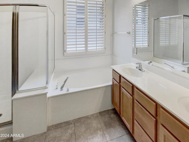 full bath featuring tile patterned floors, a garden tub, a sink, a shower stall, and double vanity