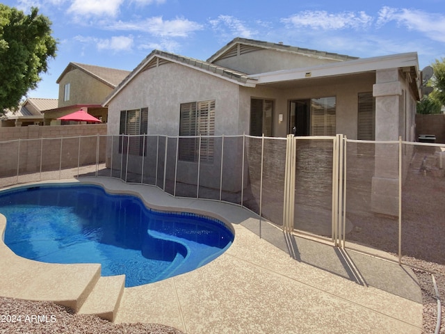 view of swimming pool featuring a patio, a fenced in pool, and fence