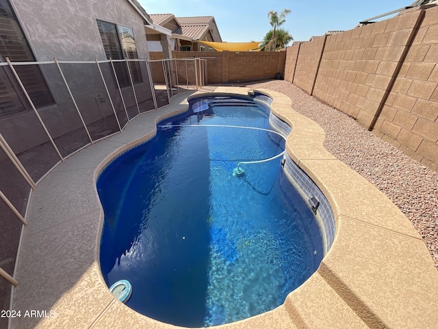 view of pool with a fenced in pool, a fenced backyard, and a patio area