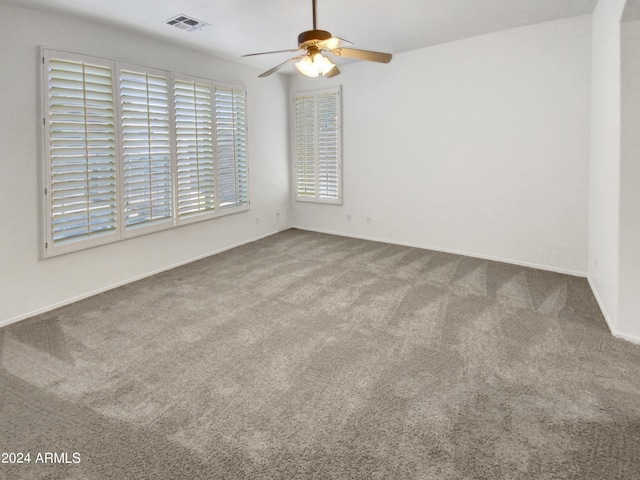 carpeted empty room featuring ceiling fan