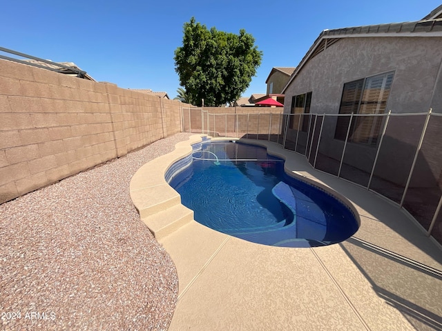 view of pool featuring a patio area, a fenced backyard, and a fenced in pool