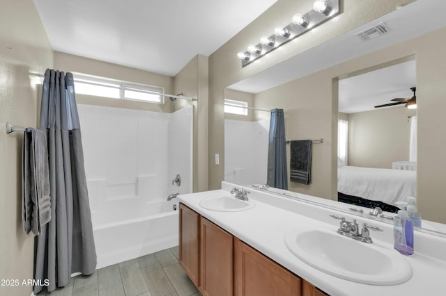 bathroom featuring ensuite bathroom, shower / bath combination with curtain, a sink, and visible vents