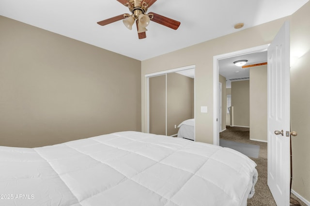 bedroom with carpet, a closet, baseboards, and a ceiling fan