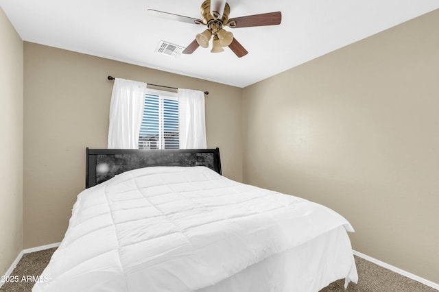 carpeted bedroom with a ceiling fan, visible vents, and baseboards