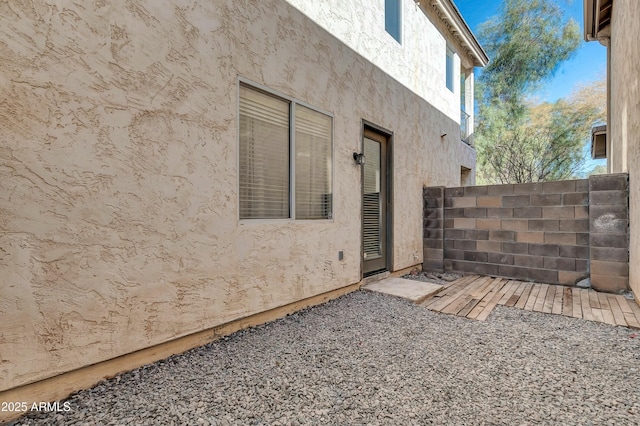 exterior space featuring fence and stucco siding