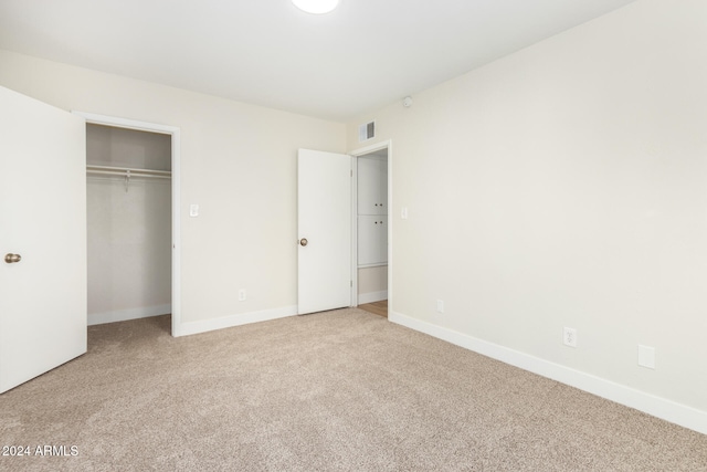 unfurnished bedroom featuring a closet and carpet