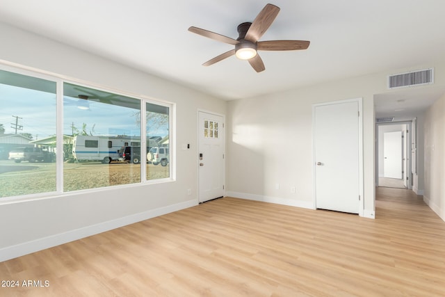 empty room featuring ceiling fan and light hardwood / wood-style flooring