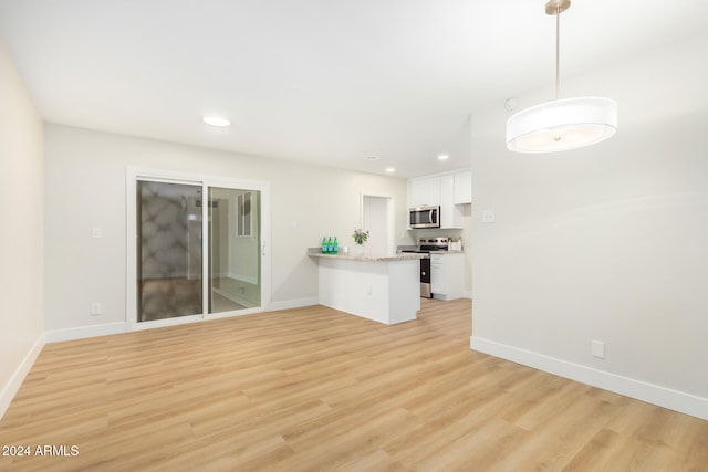 unfurnished living room with light wood-type flooring