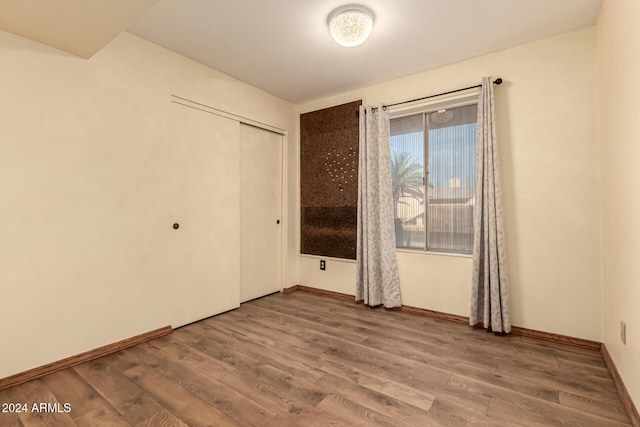 unfurnished room with hardwood / wood-style floors