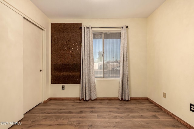 spare room with wood-type flooring